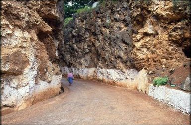 Person walking along road, Mangaia