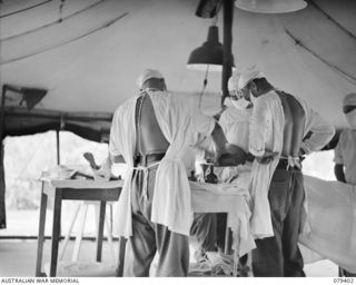 WUNUNG PLANTATION, JACQUINOT BAY, NEW BRITAIN. 1945-03-02. DOCTORS PREPARING FOR A SURGICAL OPERATION IN THE THEATRE OF THE 105TH CASUALTY CLEARING STATION