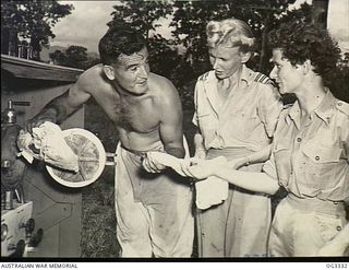 NADZAB, NEW GUINEA. C. 1944. THE LATEST DUTY UNDERTAKEN BY THE RAAF NURSING SERVICE IS THAT OF FLYING WITH CASUALTIES FROM FORWARD AREAS TO BASE HOSPITALS. KNOWN AS "FLYING ANGELS" THESE MEMBERS OF ..