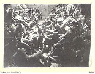 AT SEA, NEW GUINEA. 1944-05-31. MEMBERS OF BATTALION HEADQUARTERS AND B COMPANY, 37/52ND INFANTRY BATTALION ABOARD AN AMERICAN LANDING BARGE EN ROUTE FROM NAGADA TO SARANG HARBOUR WHICH IS A ..