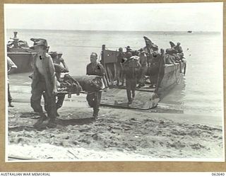 WALINGAI, NEW GUINEA. 1943-12-29. MEMBERS OF THE 4TH AUSTRALIAN FIELD AMBULANCE UNLOADING THEIR EQUIPMENT ON THE BEACH NORTH OF WALINGAI. SHOWN ARE: N170611 PRIVATE J. J. DEVER (1); VX106516 ..