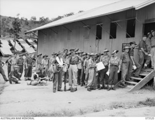 PORT MORESBY, NEW GUINEA. 1944-05-31. SOLDIERS DISCHARGED FROM ARMY HOSPITALS AND CONVALESCENT AREAS, QUEUE FOR AN ISSUE OF CLOTHING AND EQUIPMENT OUTSIDE THE QUARTERMASTER'S STORE AT THE NEW ..