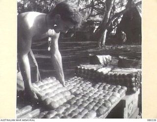 DUGUMUR, NEW GUINEA. 1944-07. PART OF THE OUTPUT OF BREAD BAKED ON THE BEACH FOR MEMBERS OF THE 4TH INFANTRY BATTALION