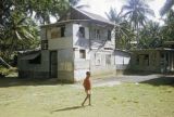 Federated States of Micronesia, village boy outside home in Chuuk State