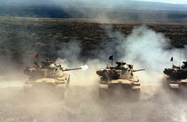 M-60A1 Reliability Improved System Equipment (RISE) main battle tanks of A Troop, 3rd Squadron, 4th Cavarly, 25th Infantry Division, fire their guns during a live-fire training exercise on the tank range. (Substandard image)