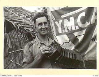 1942-12-17. PAPUA. Y.M.C.A. OFFICER, PERN HOOPER, ONE OF THE BEST KNOWN IDENTITIES BETWEEN PORT MORESBY AND THE NORTH COAST OF NEW GUINEA. EACH DAY HE SERVES UPWARDS OF 1400 CUPS OF TEA. HIS DAY'S ..