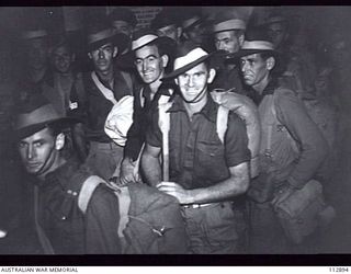 SYDNEY, NSW 1945-08-07. A GROUP OF AUSTRALIAN ARMY PERSONNEL FROM NEW GUINEA, DUE FOR DISCHARGE UNDER THE 5 YEAR PLAN, AT WHARF 12, DARLING HARBOUR. THEY HAVE JUST DISEMBARKED FROM THE SS TAROONA