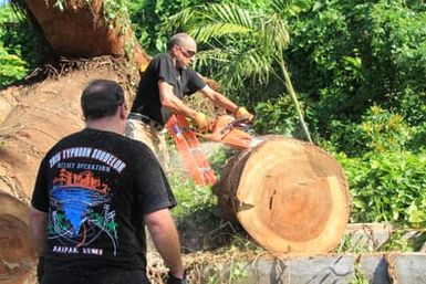 When Typhoon Soudelor hit Saipan in August 2015, it affected more than just its human residents--the Saipan Zoo was also heavily impacted. None of the animals were hurt, but the facilities were damaged, and because the zoo is a private, for-profit organization, it was not eligible for FEMA assistance. Forced to close the zoo for safety reasons, owner Frank Aldan set up a GoFundMe account on Facebook to seek additional funds to make the necessary repairs. Through this effort, several of our team members found out about Frank's dilemma and volunteered their time to help him reopen the zoo. Since mid-August, FEMA volunteers have sent their Saturdays clearing debris, cutting trees and providing food to help the zoo recover. One of the largest trees on the island was on the zoo's property, and the typhoon blew it over. Here, FEMA's Stephen DeBlasio cuts a segment of the tree with a chainsaw while Ryan Brown looks on.