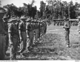 Major General W Bridgeford, General Officer Commanding 3rd Division, accompanied by Brigadier H H Hammer, Commander 15th Infantry Brigade, congratulating winners of the Mention in Despatches award. ..