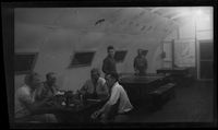 [Servicemen relaxing in Quonset hut]