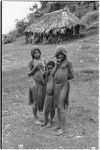 Fainjur: woman with net cap and many strings of trade beads, adolescent girl with barkcloth cap, and child