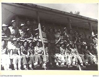 OCEAN ISLAND. 1945-10-01. TROOPS OF THE OCCUPATION FORCE ON OCEAN ISLAND, B COMPANY, 31/51 INFANTRY BATTALION, PICTURED IN THE SHADE OF THE HOUSE IN WHICH THEY ARE QUARTERED