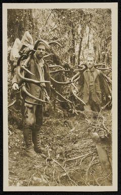 Guy and Leslie Murrell carrying two wapite heads