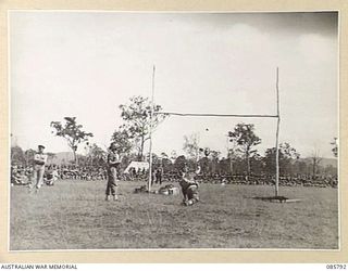 WONDECLA, ATHERTON TABLELAND, QLD. 1945-01-19. SAPPER A G MCGREGOR, 2/7 FIELD COY, COMPETING IN THE GRENADE THROWING EVENT DURING THE 9 DIVISION GYMKHANA AND RACE MEETING HELD AT THE HERBERTON ..