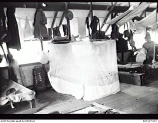 RABAUL, NEW GUINEA. 1941-12. INTERIOR VIEW OF THE SLEEPING QUARTERS OF THE 17TH ANTI-TANK BATTERY, ROYAL AUSTRALIAN ARTILLERY. THE BUNK OF NX60128 GUNNER LES J. LYONS IS FULLY ENCLOSED BY MOSQUITO ..