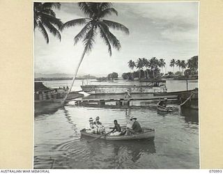 LABU, NEW GUINEA, 1944-03-10. THE LABU LAGOON ENTRANCE AND THE LABU END OF THE LAE - LABU FERRY SERVICE. THE WHARF IS USED BY THE 1ST WATERCRAFT WORKSHOPS, AUSTRALIAN ELECTRICAL AND MECHANICAL ..