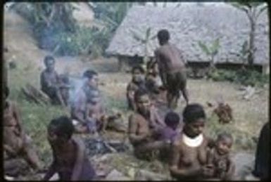 Women and children outside the Cooks' house, woman (r) wears shell valuable