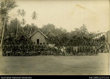 A group of Gulf Division natives with a Catholic missionary in the centre