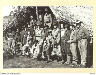 DUMPU, NEW GUINEA. 1944-01-25. MEN OF "B" COMPANY 2/1ST GUARD REGIMENT OUTSIDE THEIR MESS HUT. IDENTIFIED PERSONNEL ARE: NX94534 CORPORAL T.H. ROSE (1); QX15334 LANCE CORPORAL R. MCLEAY (2); ..