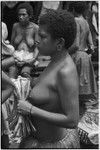 Mortuary ceremony: woman holds banana leaf bundle (wealth item)