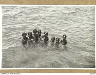 LEILEI, PAPUA. 1943-12-02. NATIVE CHILDREN ENJOYING A SWIM IN THE SEA