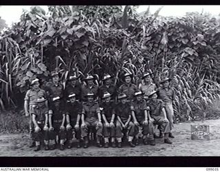 Group portrait of the personnel of 237 Supply Depot Platoon, 30 Advanced Supply Depot. Left to right, back row: NX171213 Corporal (Cpl) L A Massey; NX171300 Cpl W H T Martell; T18053 Private (Pte) ..