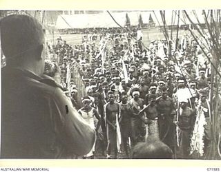 SONG RIVER, FINSCHHAFEN AREA, NEW GUINEA. 1944-03-26. NX12229 LIEUTENANT COLONEL H. T. ALLAN OBE MC (1), OFFICER COMMANDING FINSCHHAFEN BASE SUB-AREA, USING A MICROPHONE TO ADDRESS NATIVES DURING A ..