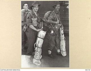 CAIRNS, QLD. 1944-10-28. LANCE-CORPORAL K.J.F. BREARLEY (1), WARRANT OFFICER II, F. DUE (2), AND L/CPL C.C.B. WARREN (3), MEMBERS OF A FIELD SECURITY SECTION, HEADQUARTERS S6 DIVISION, ABOUT TO GO ..