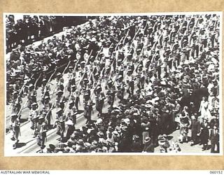 MELBOURNE, AUS. 1943-11-18. TROOPS OF THE 17TH AUSTRALIAN INFANTRY BRIGADE MARCHING ALONG SWANSTON STREET UPON ITS RETURN TO THE MAINLAND AFTER A LONG TERM OF ACTIVE SERVICE IN NEW GUINEA