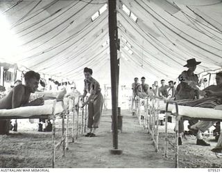 MADANG, NEW GUINEA. 1944-08-25. AN INTERIOR VIEW OF WARD 8 WHICH IS TYPICAL OF THE 5 WARDS IN USE AT PRESENT AT THE 2/11TH GENERAL HOSPITAL. IDENTIFIED PERSONNEL ARE:- NFX138773 SISTER B.I. HARRIS, ..