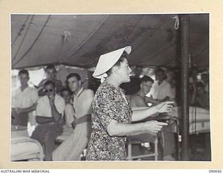 TOROKINA, BOUGAINVILLE. 1945-04-16. WILLA HOKIN, A MEMBER OF THE BOB DYER CONCERT PARTY, ENTERTAINING TROOPS, SINGING IN A WARD AT THE 2/1ST GENERAL HOSPITAL DURING THEIR VISIT TO THE AREA