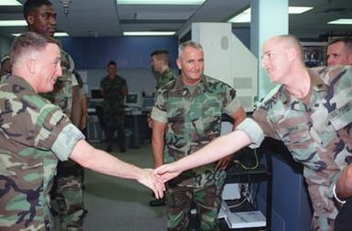 General Charles C. Krulak, 31st Commandant of the Marine Corps (left), and Sergeant Major of the Marine Corps, Harold G. Lee (center), stop to meet with the Marines at the Systems Integration Hub, while touring Marine Forces Pacific headquarters at Camp Smith, Hawaii