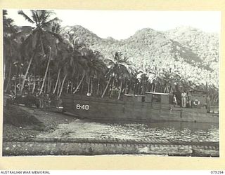 KEIP, NEW BRITAIN. 1945-02-17. TROOPS OF THE 14TH SUPPLY DEPOT PLATOON LOADING STORES AND AMMUNITION ABOARD AN LCM (LANDING CRAFT MECHANISED) FOR TRANSPORT TO KAMANDRAN