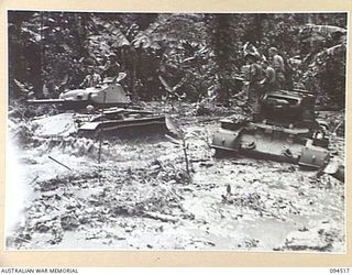 TOROKINA, BOUGAINVILLE, 1945-08-02. AN M24 GENERAL CHAFFEE LIGHT TANK PASSING A MATILDA TANK BOGGED IN SWAMP DURING TRIALS CONDUCTED FOR THE WAR OFFICE