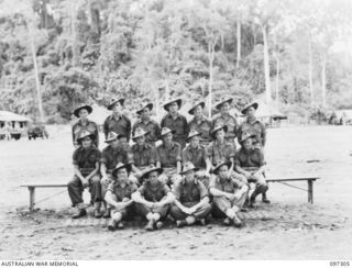Group portrait of members of 13 Platoon, C Company, 58/59 Infantry Battalion. Identified, back row, left to right: Private (Pte) R Wyatt; Corporal A Dempster; Pte A L Barrat; Lance Sergeant ..