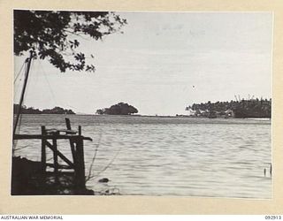 JACQUINOT BAY, NEW BRITAIN. 1945-06-11. PORTION OF THE WATERFRONT IN 5 BASE SUB-AREA. A FLYING BOAT IS JUST VISIBLE AT ANCHORAGE IN CENTRE BACKGROUND