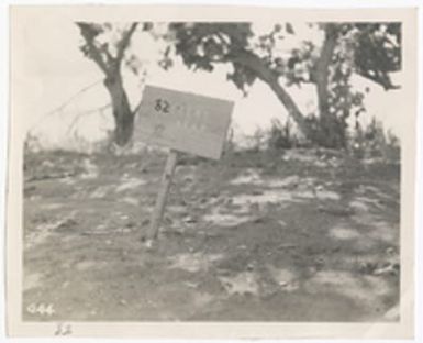 [Sign reading "82 enemy dead," Saipan]