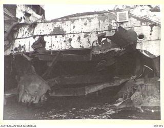 MOILA POINT, BOUGAINVILLE. 1945-09-28. GAPING HOLE IN SIDE OF THE JAPANESE MERCHANT SHIP, HITATI MARU, WHICH RAN ASHORE NEAR KANGU HILL AFTER SUCCESSFUL ATTACK BY ALLIED AIRCRAFT