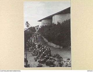 OCEAN ISLAND. 1945-10-02. FOLLOWING THE SURRENDER OF THE JAPANESE, TROOPS OF 31/51 INFANTRY BATTALION OCCUPIED THE ISLAND AND JAPANESE TROOPS WERE EVACUATED TO TOROKINA. SHOWN, JAPANESE SITTING ..