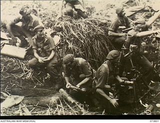 Karkar Island, New Guinea. 1944-06-03. A mortar detachment from B Company, 37/52nd Infantry Battalion going into action on the island. Identified personnel are: Left to right: V197621 Private (Pte) ..