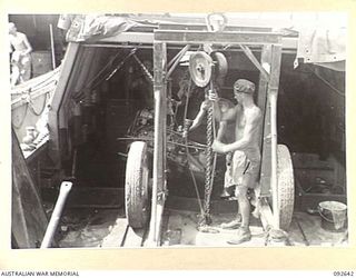 PURUATA ISLAND, SOUTH BOUGAINVILLE. 1945-05-29. THE IMPROVISED EQUIPMENT USED BY 42 LANDING CRAFT COMPANY TO LIFT ENGINES FROM BARGES DURING MAINTENANCE WORK