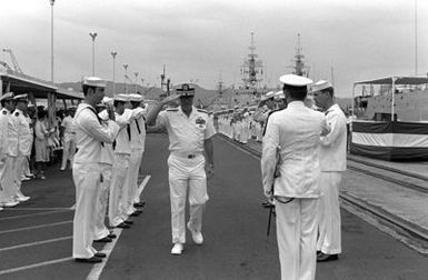 Sideboys exchange salutes with a flag officer as he arrives for the decommissioning of the destroyer USS MORTON (DD-948)