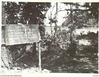 SIKI COVE, FINSCHHAFEN AREA, NEW GUINEA. 1944-03-13. ONE OF MANY BATTLE SIGNS IN THE FINSCHHAFEN AREA, THIS SIGN RECORDS ACTIVITIES OF THE 2/28TH INFANTRY BATTALION