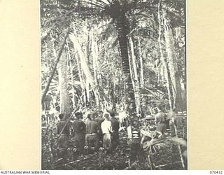 WEBER POINT, NEW GUINEA, 1944-02-14. VX117169 CHAPLAIN F.J. MCKENNA, (ROMAN CATHOLIC), CONDUCTS REQUIEM MASS AT 8TH INFANTRY BRIGADE HEADQUARTERS, FOR WX36148 WARRANT OFFICER II, J.A. KEHOE, 30TH ..