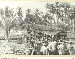 JACQUINOT BAY, NEW BRITAIN. 1944-11-16. TROOPS OF HEADQUARTERS, 5TH BASE SUB AREA UNLOADING STORES AT THEIR NEW CAMP SITE IN THE PALMALMAL PLANTATION