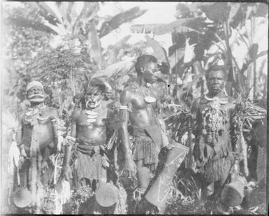 Four decorated men with hand drums, Awar, Sepik River, New Guinea, 1935 / Sarah Chinnery