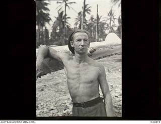 MOMOTE, LOS NEGROS ISLAND, ADMIRALTY ISLANDS. 1944-03-18. A BARE-CHESTED LEADING AIRCRAFTMAN J. "BLUE" CRAIG OF BANKSTOWN, NSW, FITTER, LEANS ON THE WING OF A KITTYHAWK AIRCRAFT OF NO. 76 SQUADRON ..