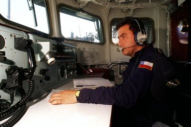 On the Chilean frigate CNS CONDELL (FFH 6), a radioman monitors communications prior to leave for sea exercises during RIMPAC '98