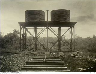 Lae, New Guinea. 1945-05-24. A prefabricated tubular steel tank stand holding two 3,000 gallon water tanks. It is designed to withstand tropical conditions