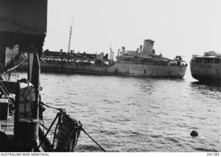 Milne Bay, Papua. c. 1943. A photograph taken from HMAS Broome showing fuel being transferred from a grounded tanker